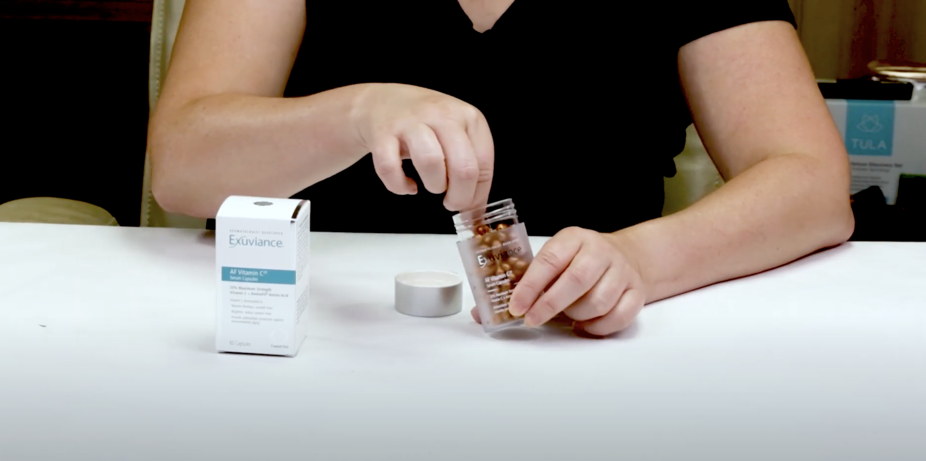 woman opening skincare exuv...