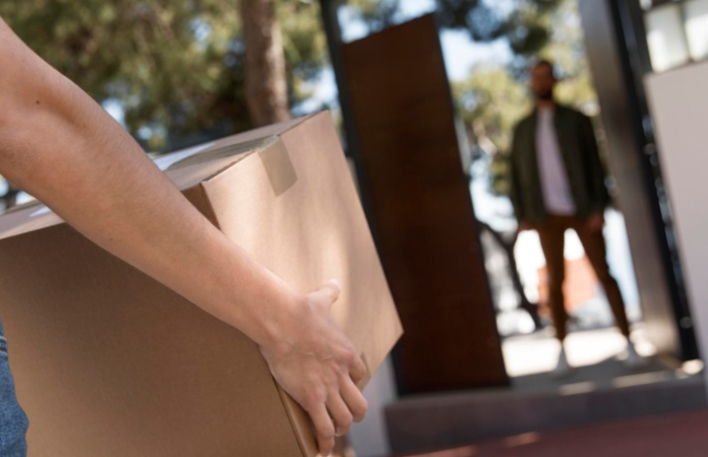 Woman delivering a package for a man