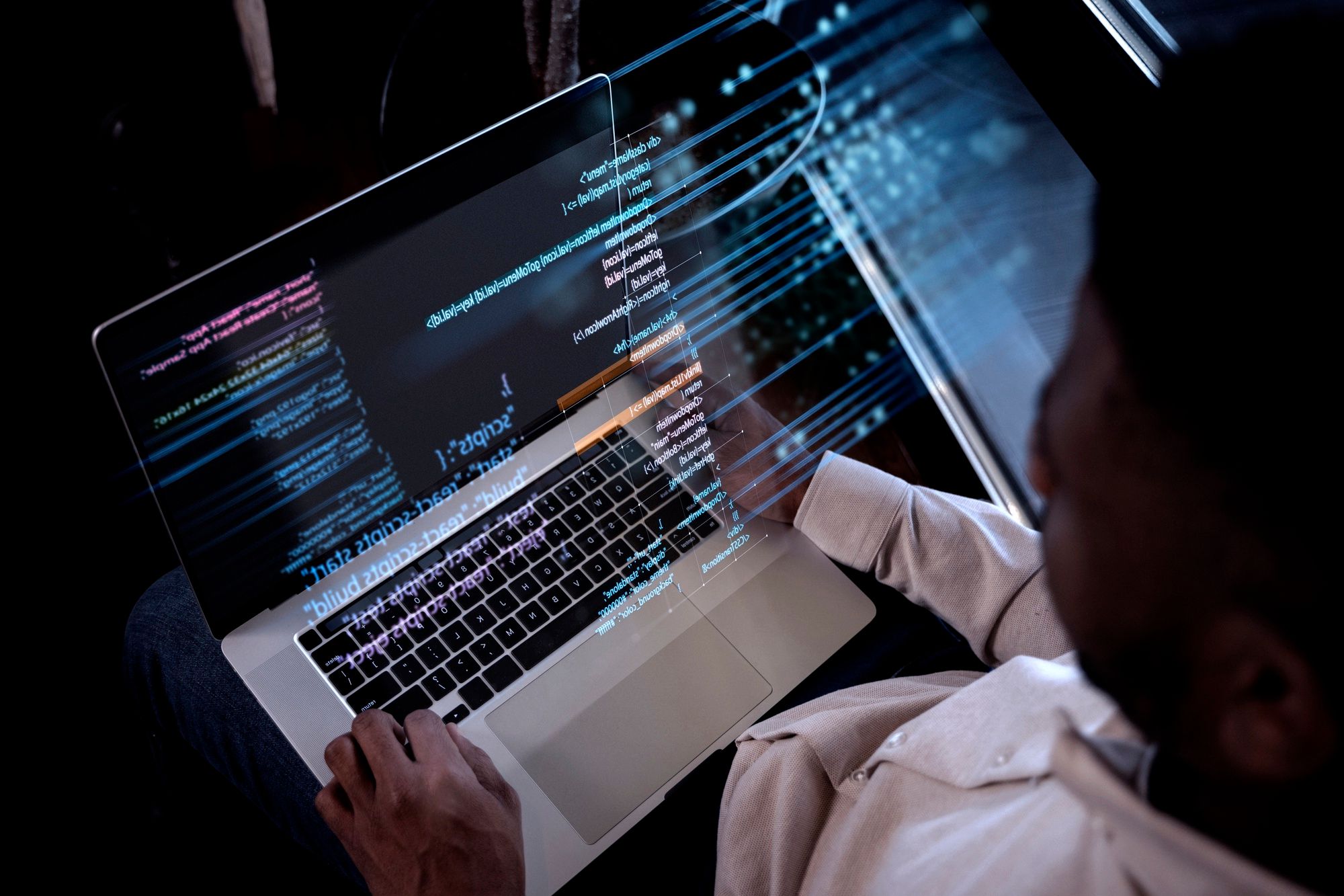Colored man sitting in front of a tablet